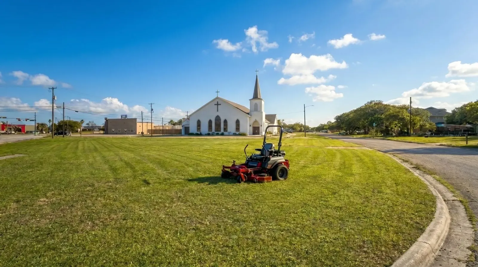 Crosscut Lawn Service mower on a freshly cut lawn with a church in the background